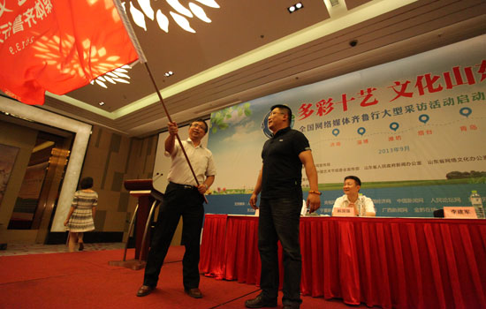 山東省委宣傳部副部長李建軍為采訪團授旗